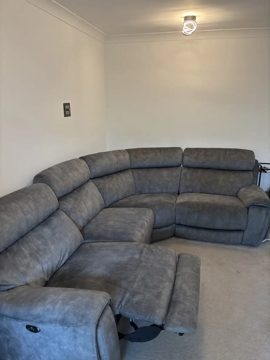 Grey l shaped recliner sofa. Oak furniture land. Only 8 months old! RRP:£2400