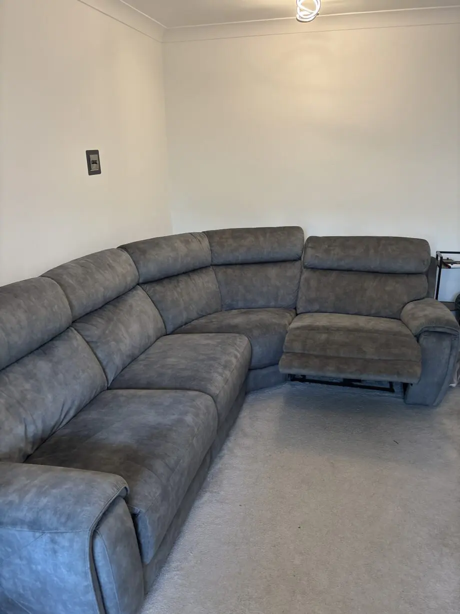 Grey l shaped recliner sofa. Oak furniture land. Only 8 months old! RRP:£2400