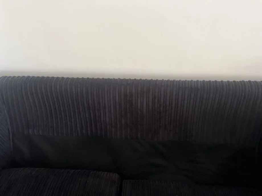 Black sofas and footstool