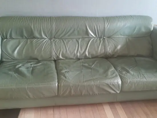 Ekornes leather sofa with oak arm trims.