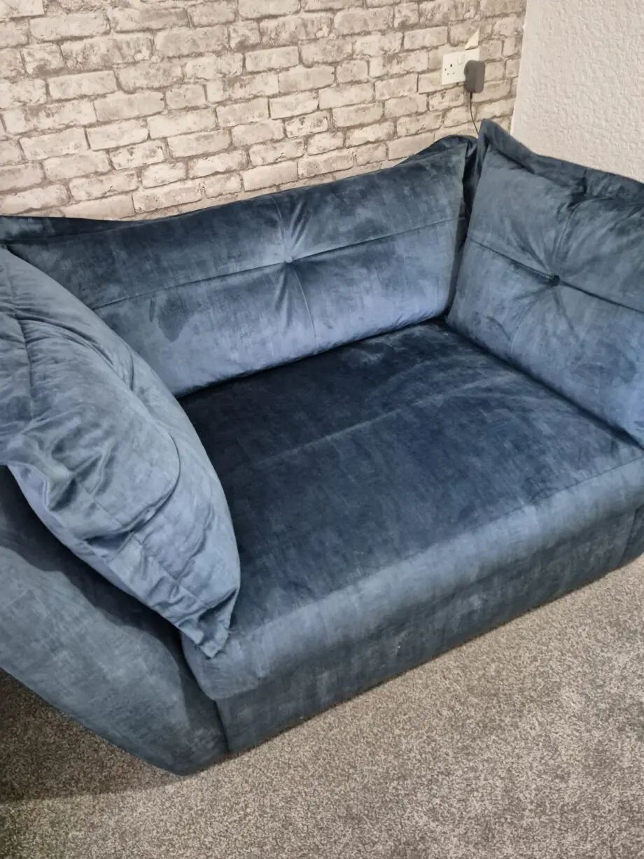 Dark blue velour snuggle sofa.