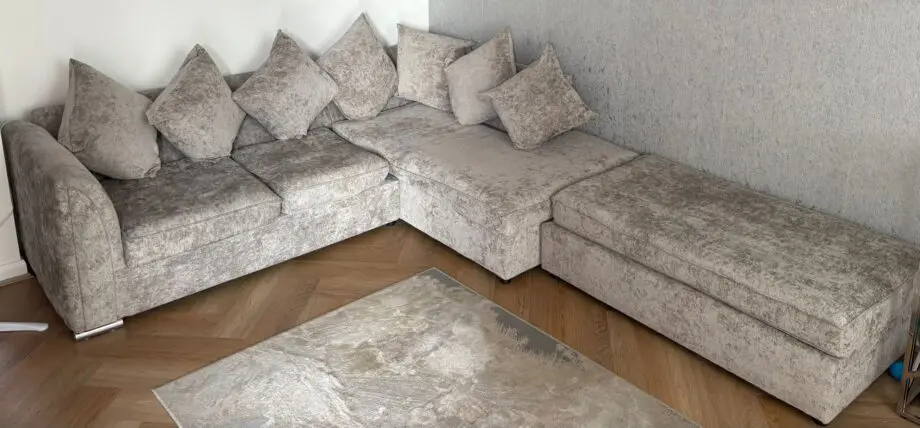 Grey corner sofa with footstool
