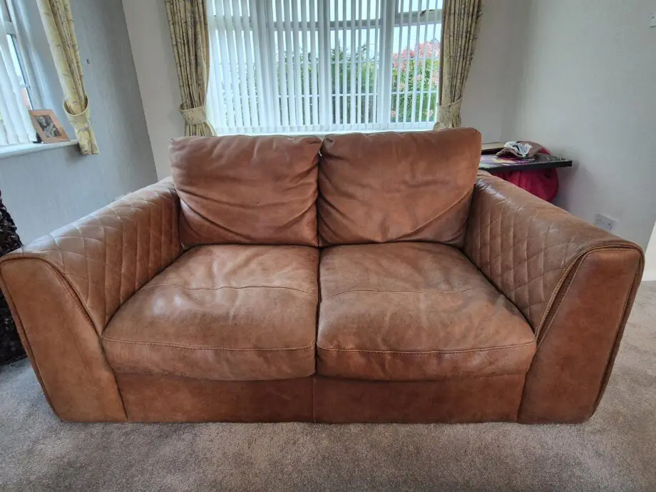 2 brown leather two-seater sofas
