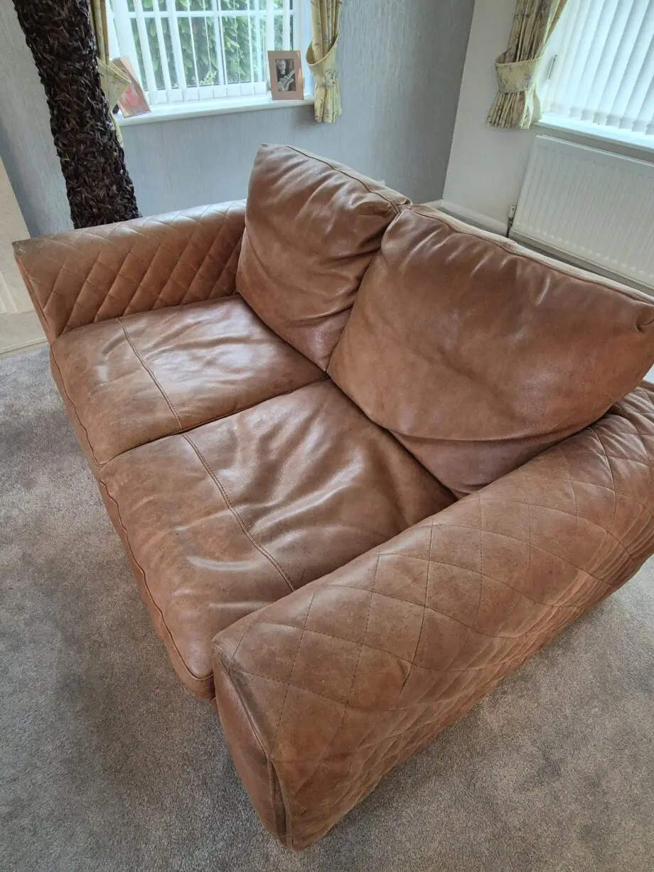 2 brown leather two-seater sofas
