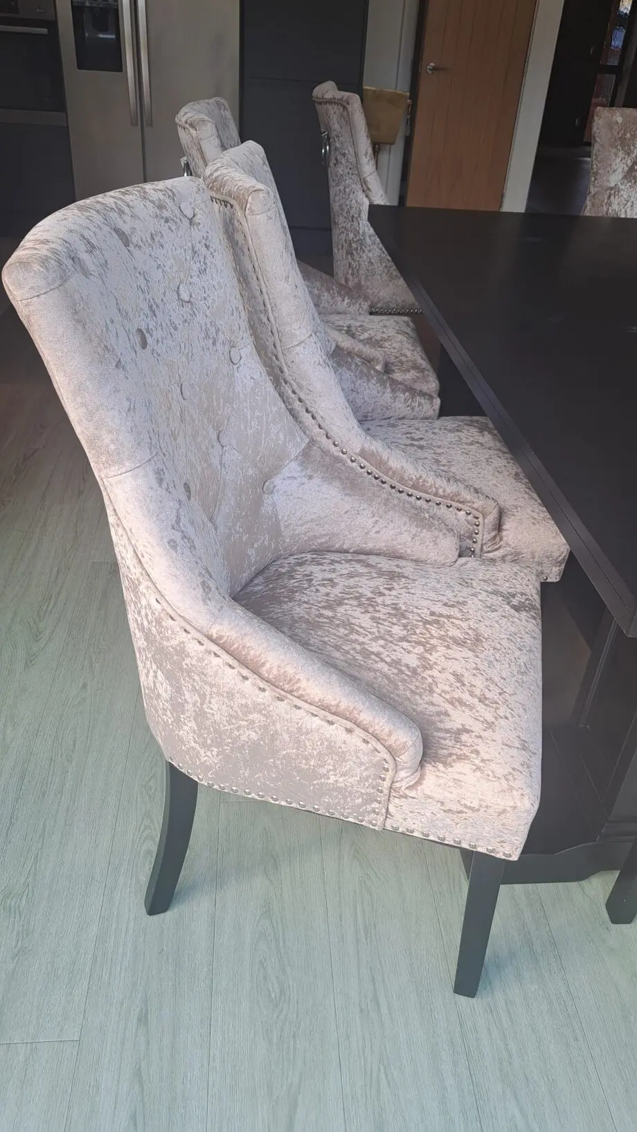 Grey/beige crushed velvet dining room chairs.