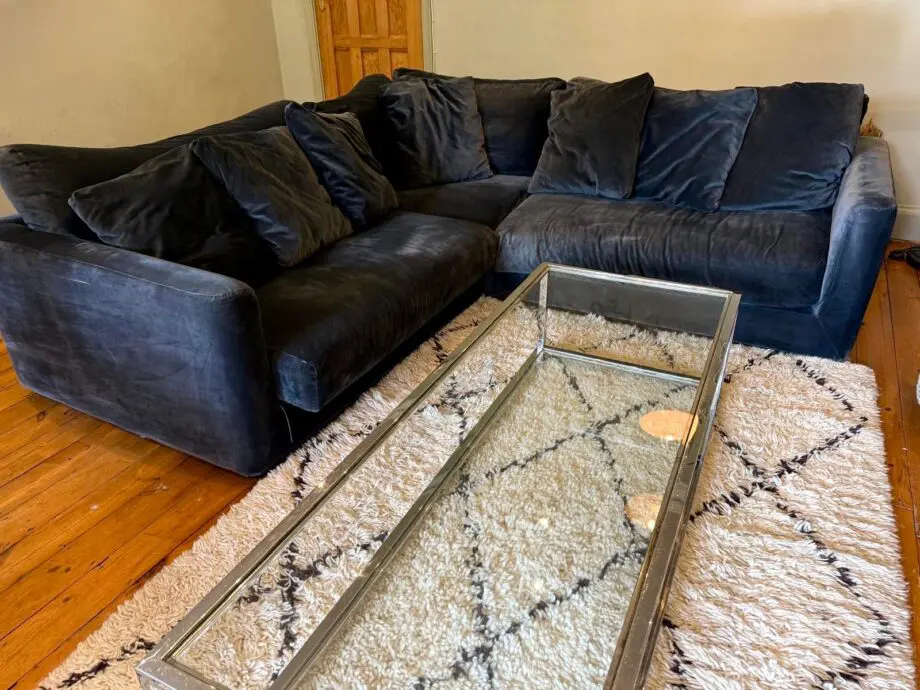 Navy blue velvet corner sofa with cushions