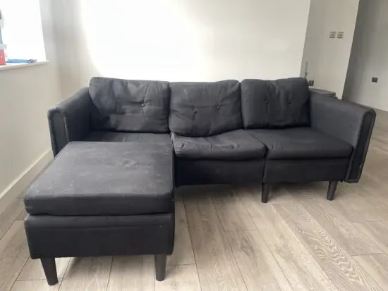 Black modern 3 seater sofa with leg stool
