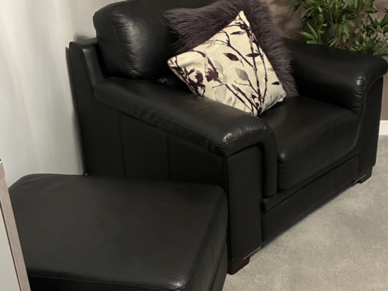 Harvey’s Black Leather Arm Chairs (x2) and Matching Foot Stool - Excellent Condition