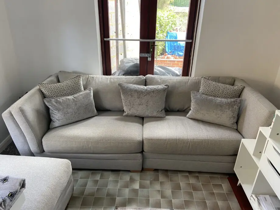 Grey fabric sofa, swivel chair and footstoll