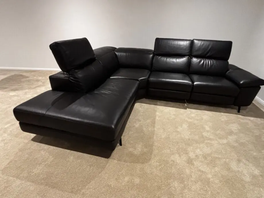 Nattuzzi black 2 electric recliners 1 month old corner sofa