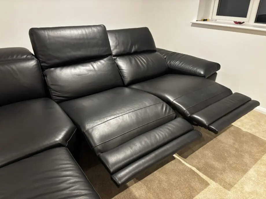 Nattuzzi black 2 electric recliners 1 month old corner sofa