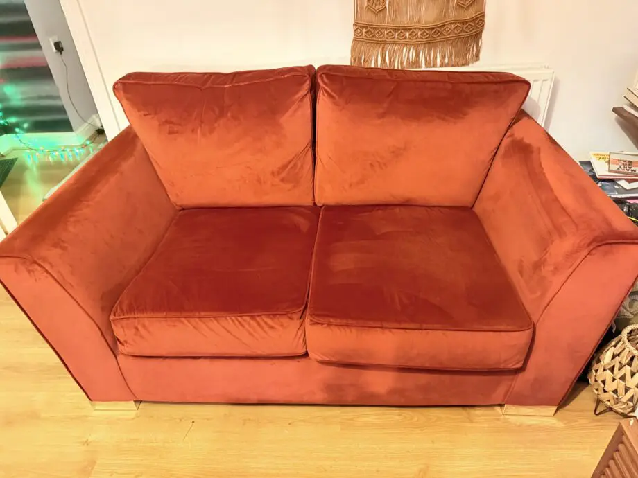 Burnt orange velvet 2 seater sofa
