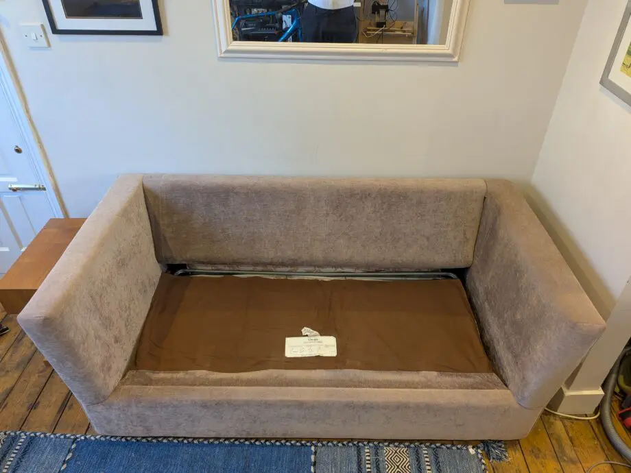Light taupe three seat sofa bed in excellent condition