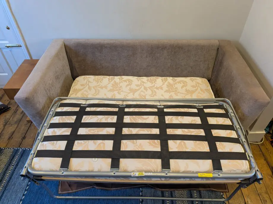 Light taupe three seat sofa bed in excellent condition