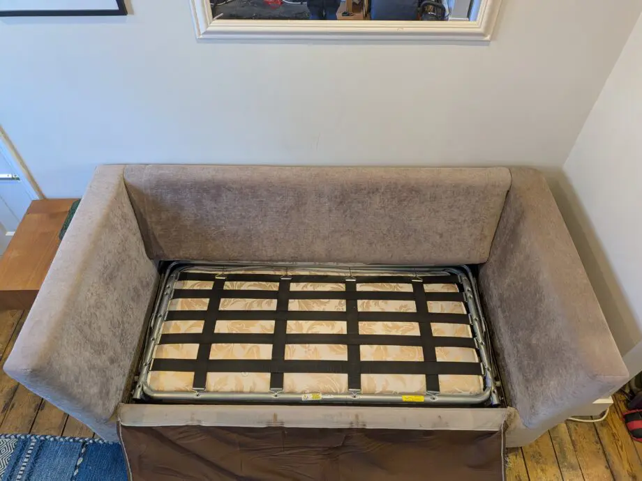 Light taupe three seat sofa bed in excellent condition