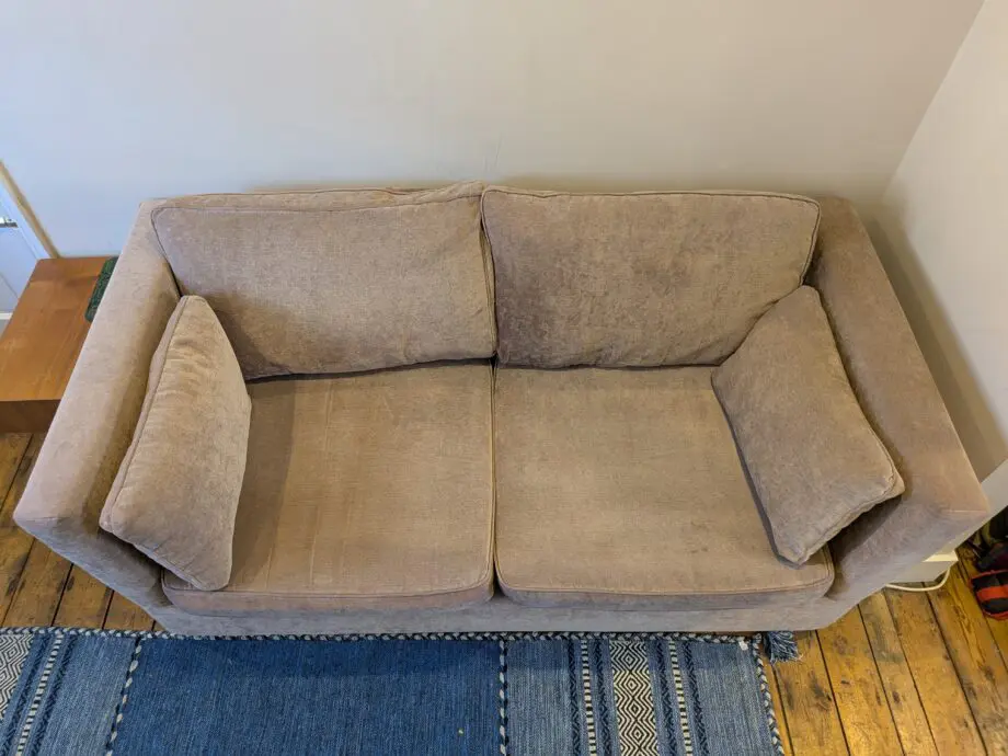 Light taupe three seat sofa bed in excellent condition