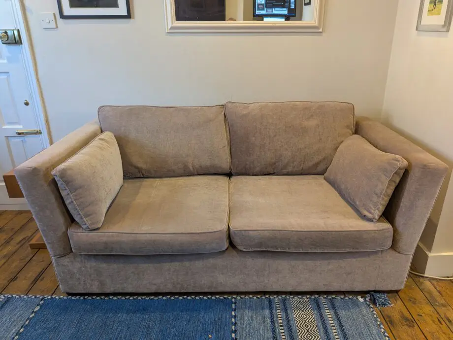 Light taupe three seat sofa bed in excellent condition