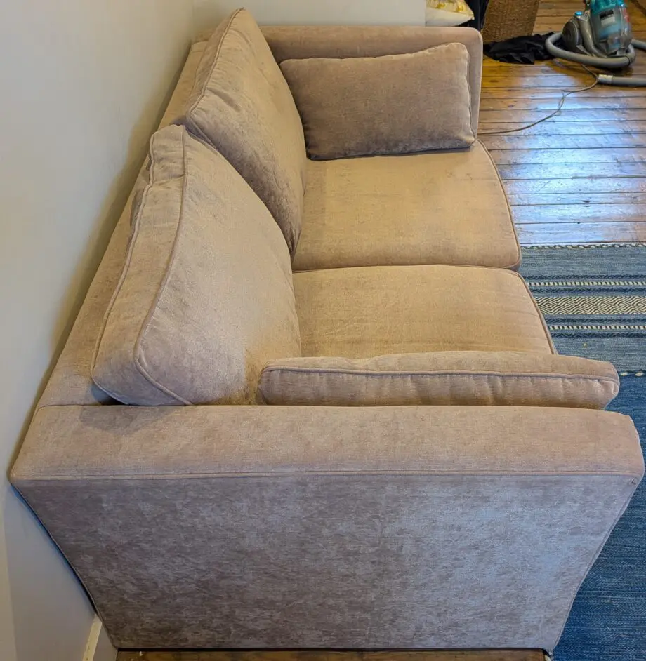 Light taupe three seat sofa bed in excellent condition
