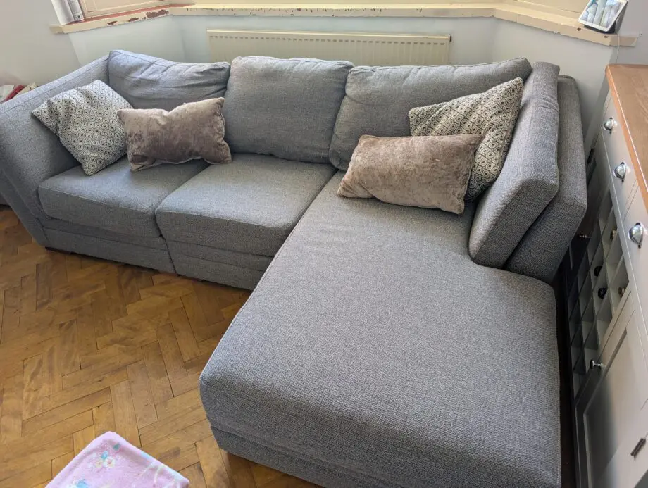 Grey corner sofa with storage footstool