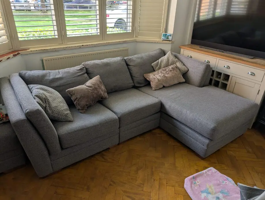 Grey corner sofa with storage footstool