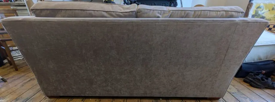 Light taupe three seat sofa bed in excellent condition