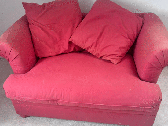 Two-seater red sofa with Sealy sprung mattress