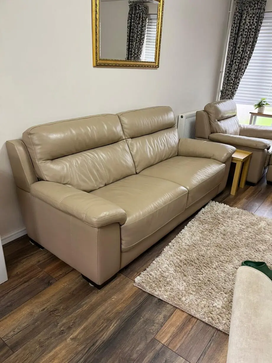 Beige 2 seater sofa with armchair and footstool