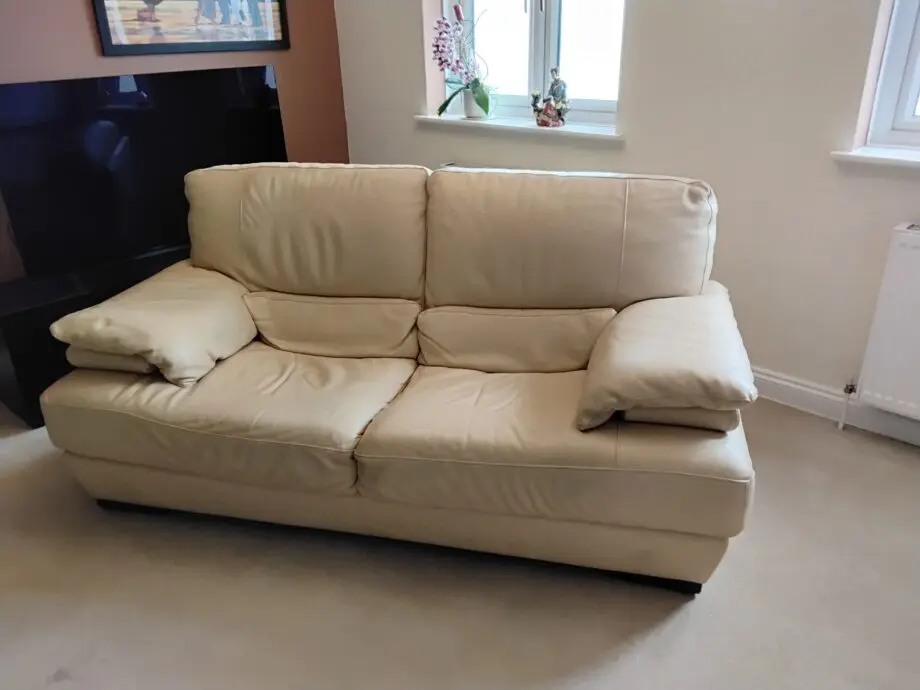 Two seater cream Italian leather sofa