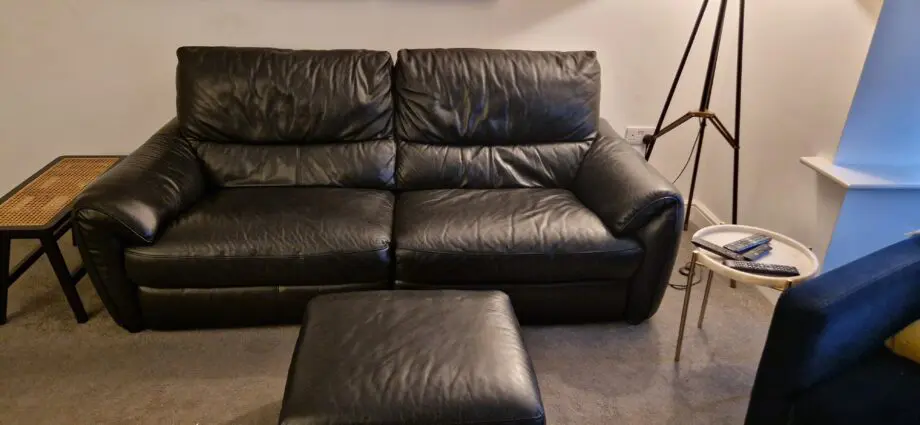 DFS black leather recliner sofas and footstool