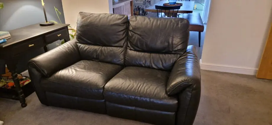 DFS black leather recliner sofas and footstool