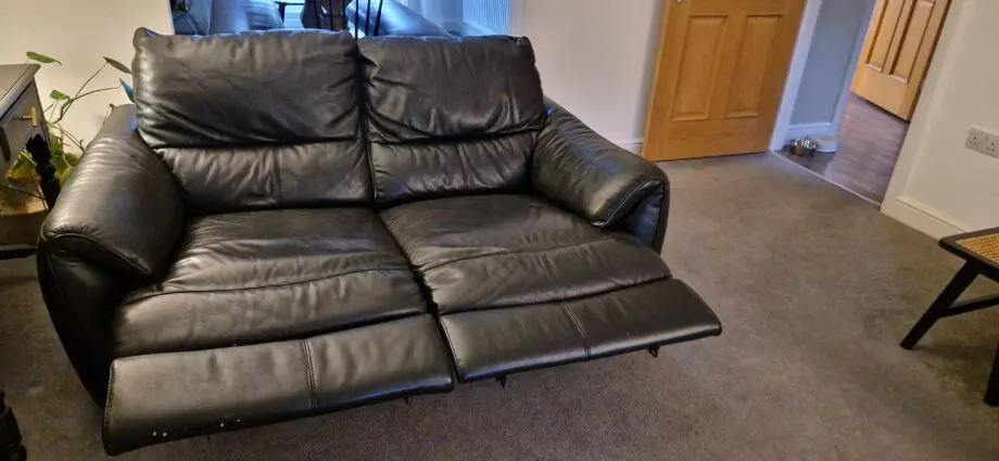 DFS black leather recliner sofas and footstool