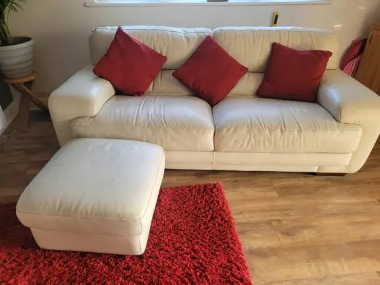 2 sofas and a foot stall