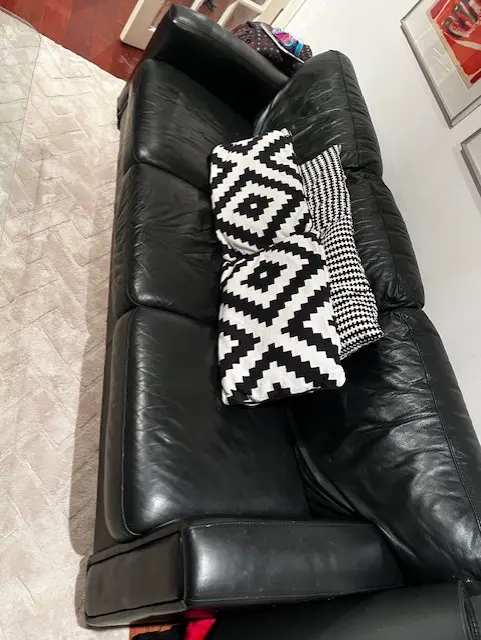 A set of 2 Black Leather sofa's