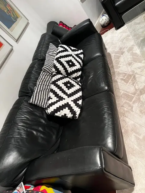 A set of 2 Black Leather sofa's