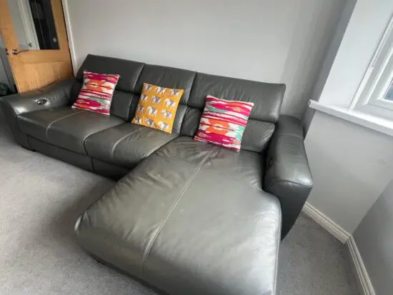 Furniture village, leather sofa with power recliner