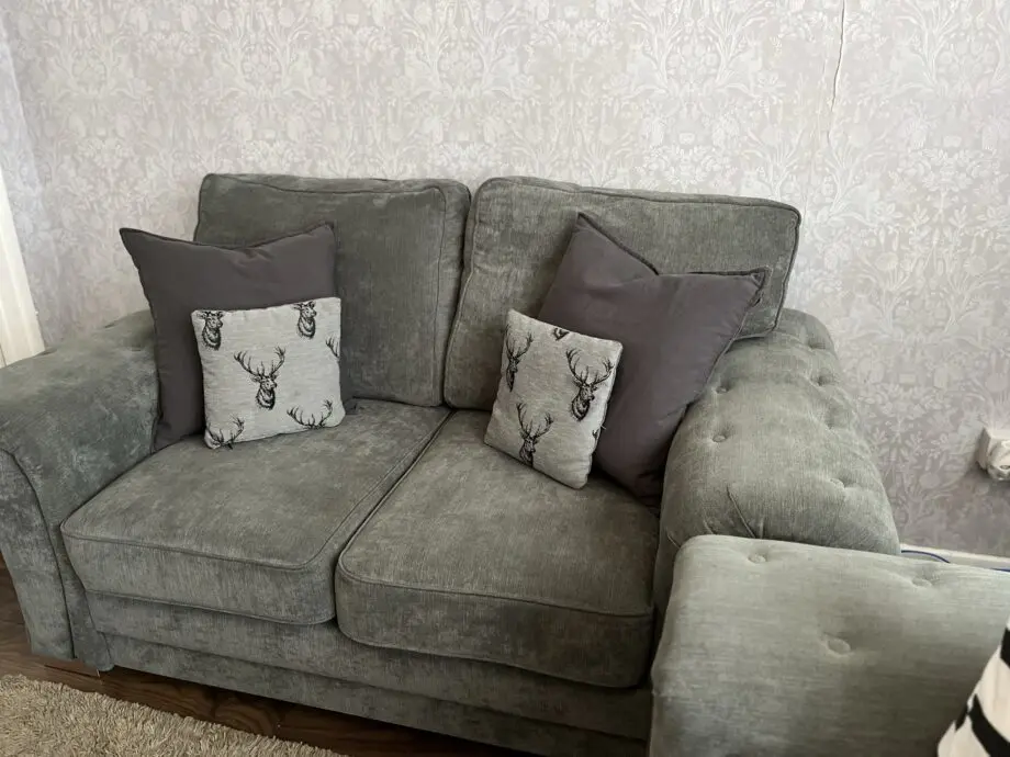 Grey sofa set, including two small cushions.