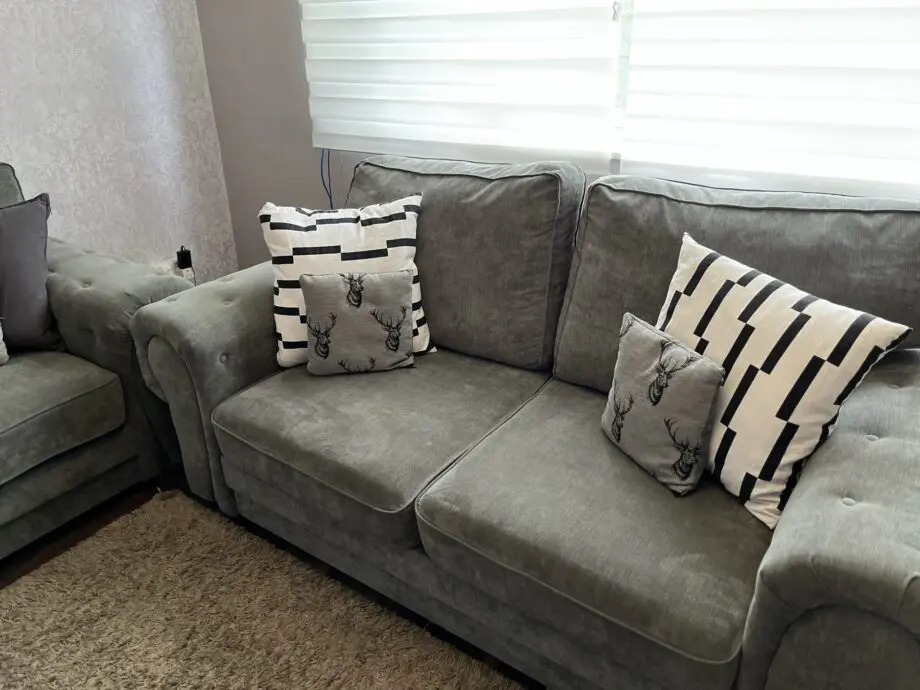 Grey sofa set, including two small cushions.
