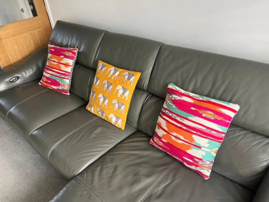 Furniture village, leather sofa with power recliner
