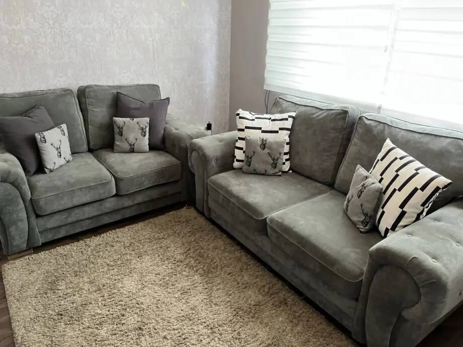 Grey sofa set, including two small cushions.