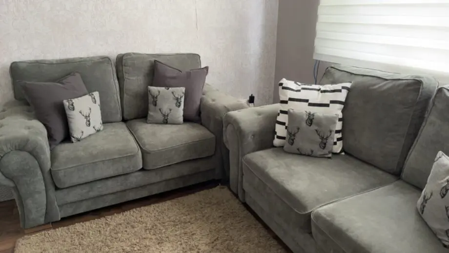 Grey sofa set, including two small cushions.