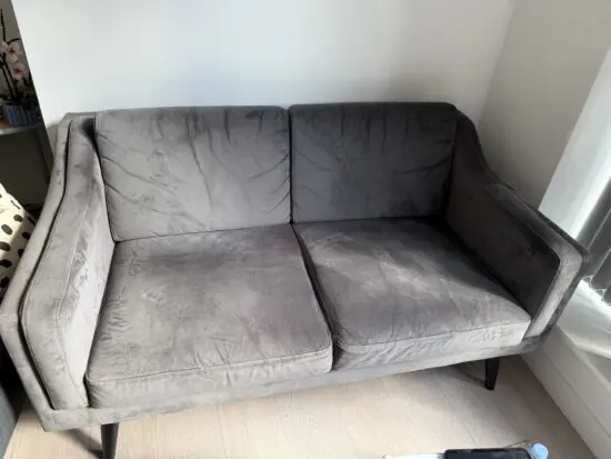 Grey fabric 2-seater sofa.