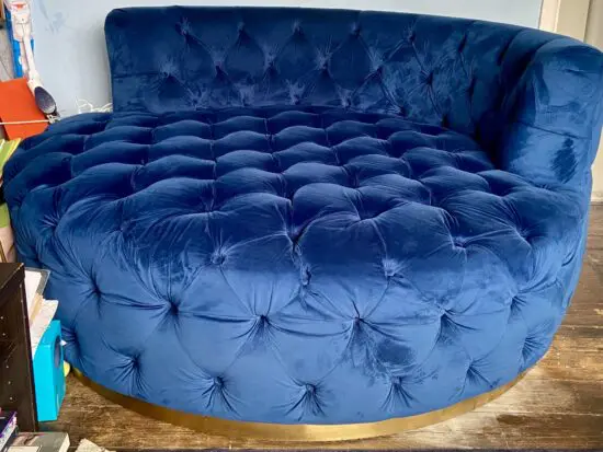 A luxurious navy blue velvet 2 seater loveseat