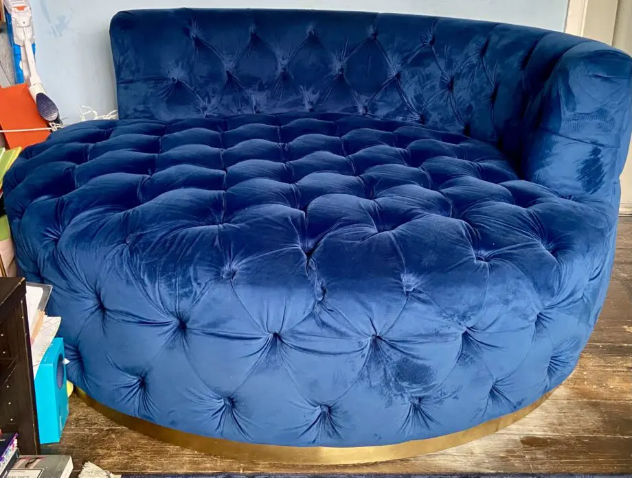A luxurious navy blue velvet 2 seater loveseat