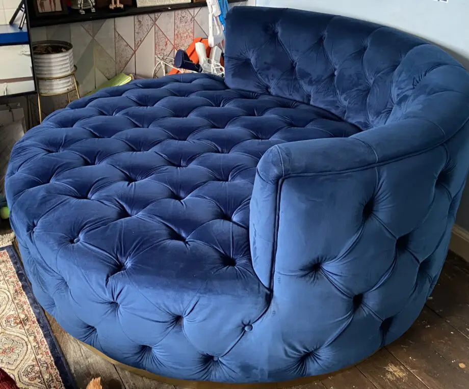 A luxurious navy blue velvet 2 seater loveseat