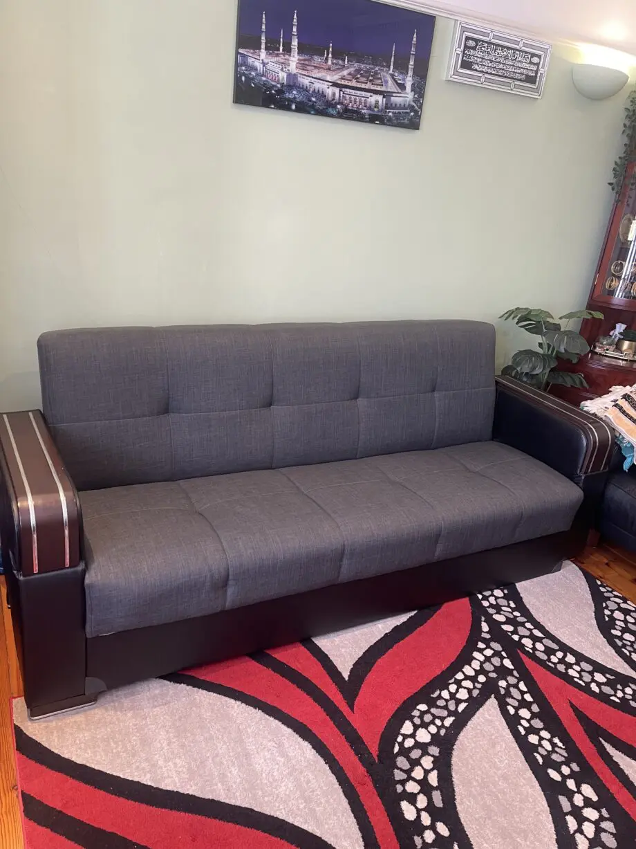 A charcoal 3 seated sofa