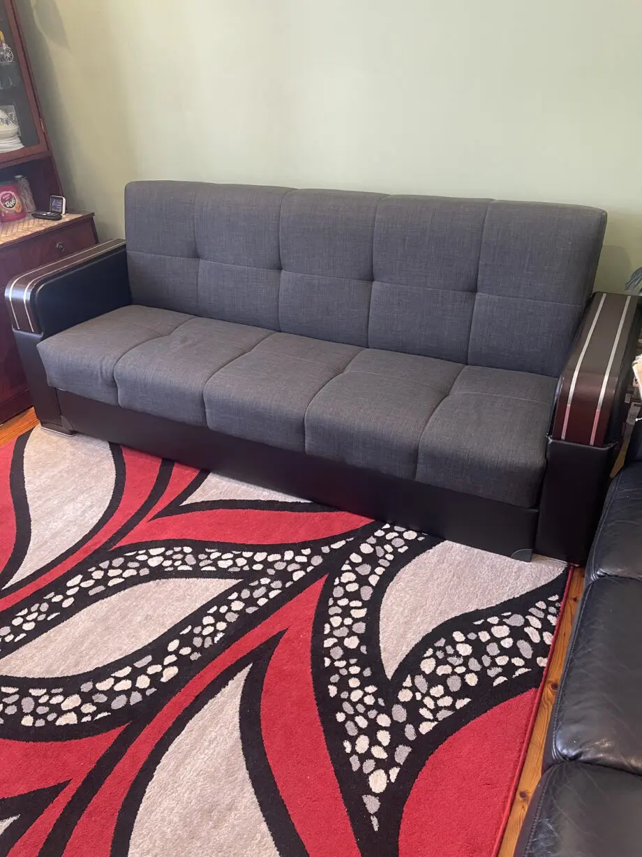 A charcoal 3 seated sofa