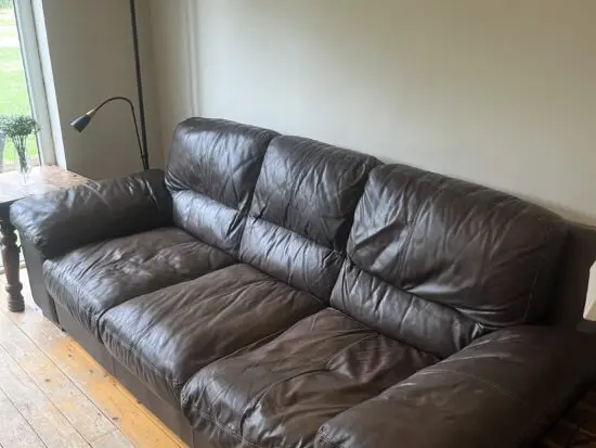 Brown leather sofas and poufees