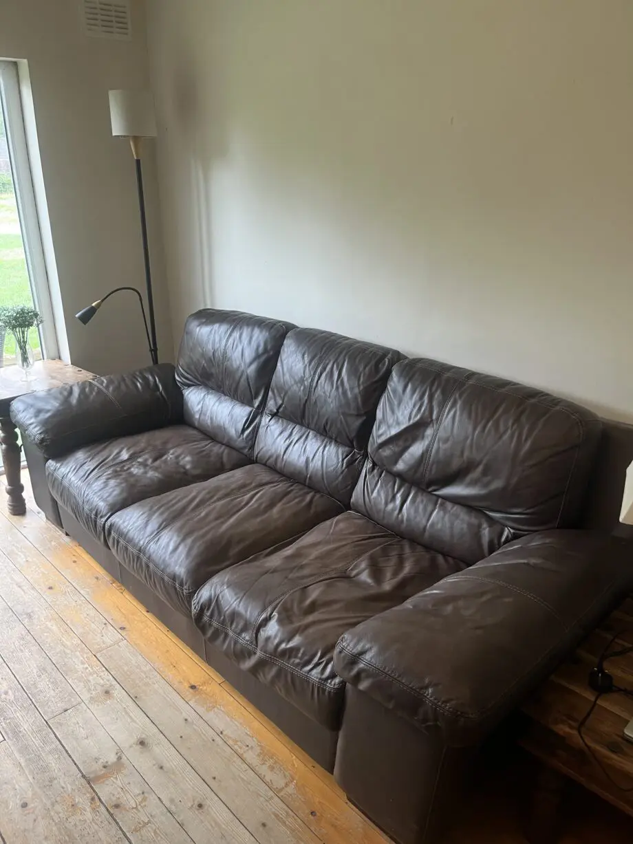 Brown leather sofas and poufees