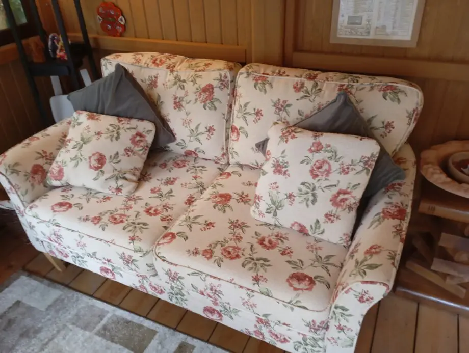DFS 2 seater floral sofa with matching foot stool