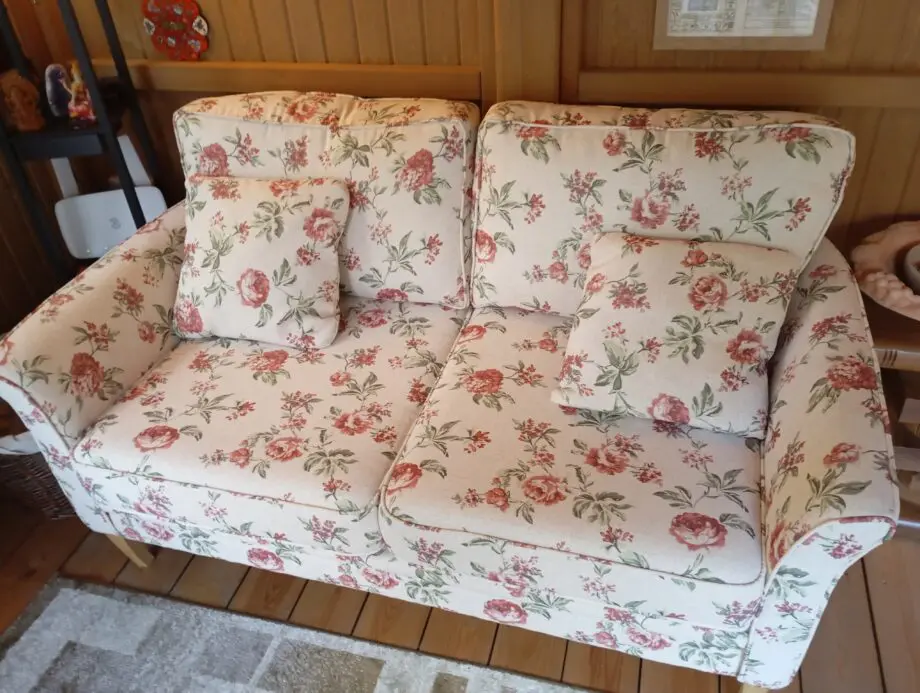 DFS 2 seater floral sofa with matching foot stool